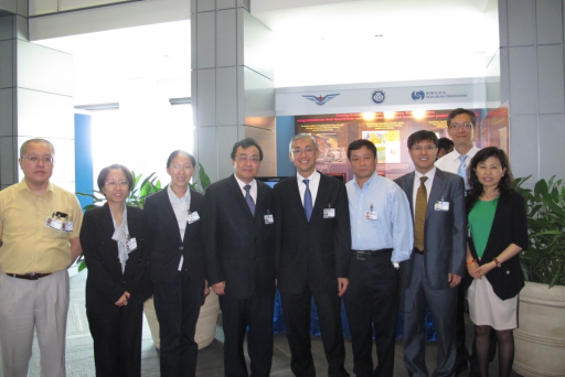 Director of Weather and Disaster Risk Reduction Services of WMO Dr. Xu Tang (4th from left), and delegates from China and Hong Kong, China standing in front of the booth showcasing aviation weather services in mainland China and Hong Kong, China