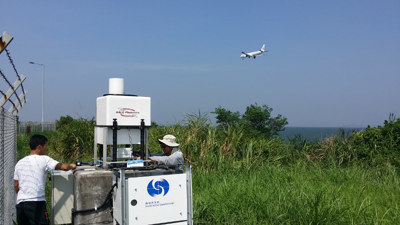 Observatory colleagues performing final checks on the short-range LIDAR at the seaside site overlooking corridor 25RA of HKIA.