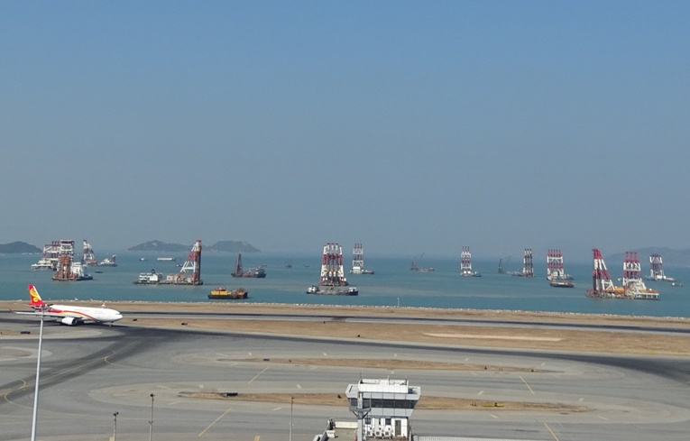 Image showing a large number of construction vessels within the three-runway system works site.