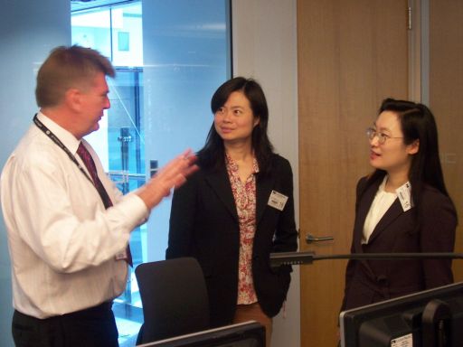 Mr Gary Greenfield, Cathay' Integrated Operations Centre Manager (1st left), explaining to the staff of the Observatory's Aviation Weather Services Branch on the operation of the Centre