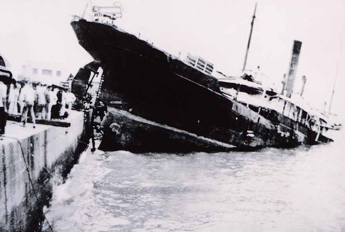 Stranded ship alongside a pier