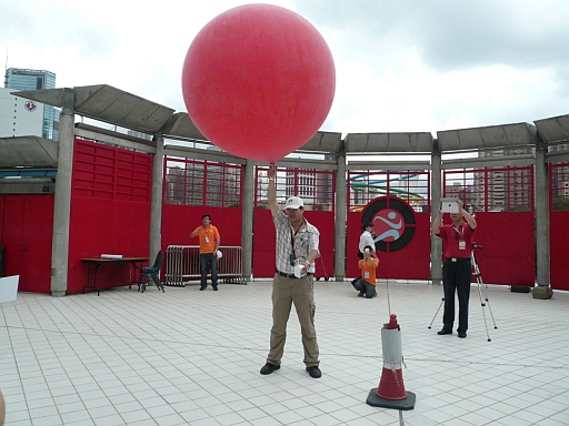 John KW Chan, Scientific Officer of the Observatory, released the weather balloon with a radiosonde to collect upper-level wind data at the Hong Kong Stadium in support of the parachute show on 1 July 2012.