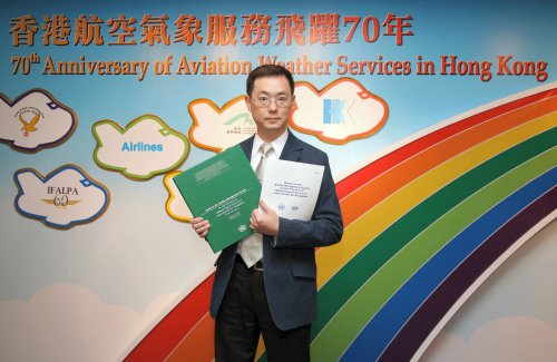 Photo: Mr. S.T. Chan holding the Manual published by ICAO (white) and the Guide published by WMO (green)