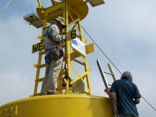 Observatory colleagues making final check of instrument installation before the launch of the weather buoy