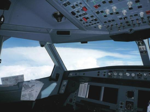 Capture of a huge thundery cloud in bright white colour through the windows of the cockpit.  The top and the anvil of the thundery clouds could be clearly seen.