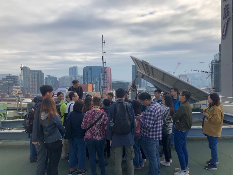 Participants conducting weather observation attentively