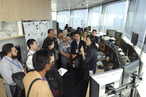 Ms Queenie Lam (the one holding a microphone), Senior Scientific Officer of the Hong Kong Observatory, introducing Hong Kong's aviation weather service to the workshop participants during a visit to the Airport Meteorological Office