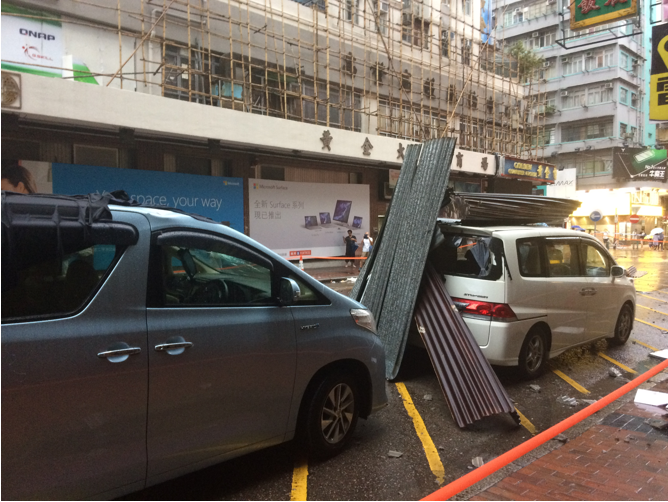 Fallen galvanized iron sheets damaged two private cars in Sham Shui Po.<br> (photo courtesy of Tam Hiu Fai)