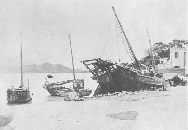 Sampans blown ashore near the road at Tai Po