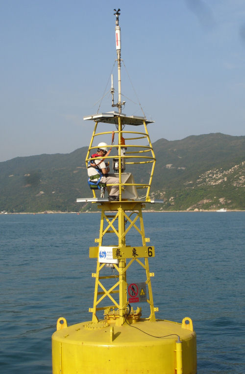 Figure 2. Technical staff of the Hong Kong Observatory conducts final checking on the weather buoy at Tai Tam Bay, the windsurfing event venue.