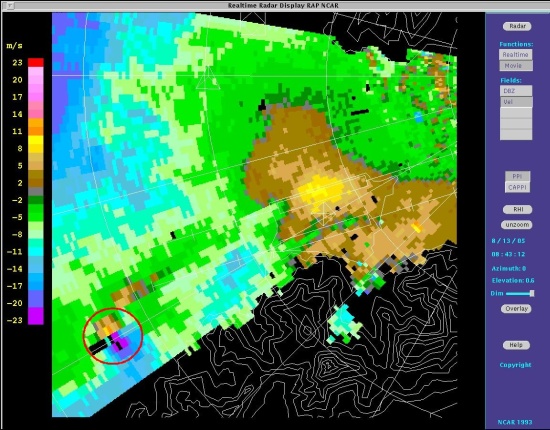 Picture taken by the Terminal Doppler Weather Radar of the Hong Kong Observatory at 4:43 p.m. on 13 August 2005.  Enclosed in circle is the location of the waterspout.  Purple/blue indicates winds blowing towards the northeast, while orange/yellow indicates winds blowing towards the southwest. Two patches of opposing winds close to one another is the typical pattern of a tornado/waterspout.