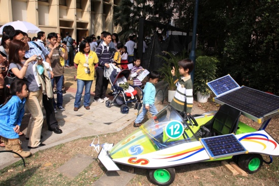 Visitors taking photos at the  'Solar Winds 2'  renewable energy car designed by Observatory staff