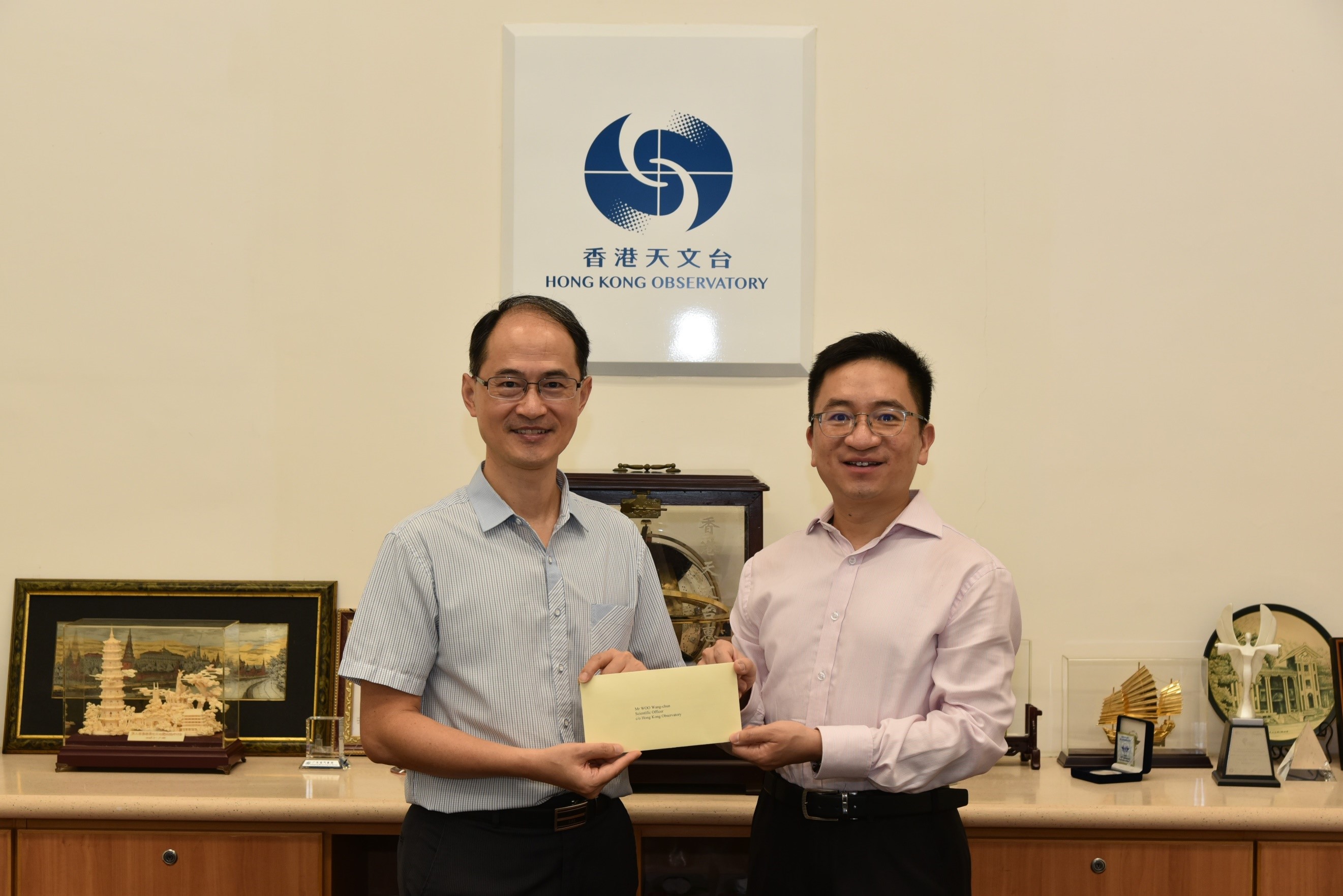 Mr Woo Wang-chun (right) was promoted to Senior Scientific Officer