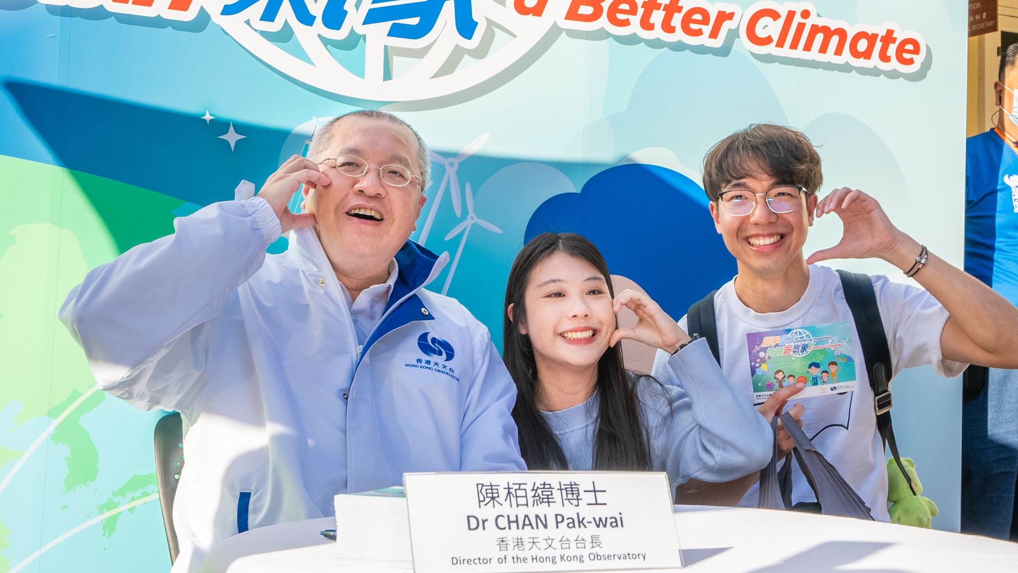 Dr Chan Pak-wai, Director of the Observatory, posing for photos with visitors.