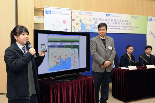 风采中学张诗琪同学﹝左﹞及周鉴明副校长﹝右﹞讲解最新启动的大珠三角天气网站对跨境学童的用处。