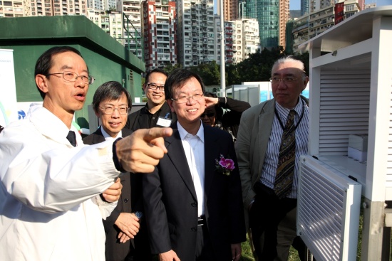 天文台台长林超英(左一)解释湾仔区自动气象站的运作